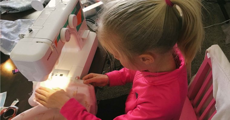 Girl sewing an Oliver + S Lazy Days Skirt