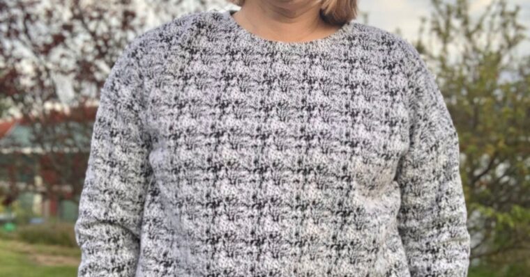 Close up of a woman wearing Bento Tee made from a black and white sweater knit